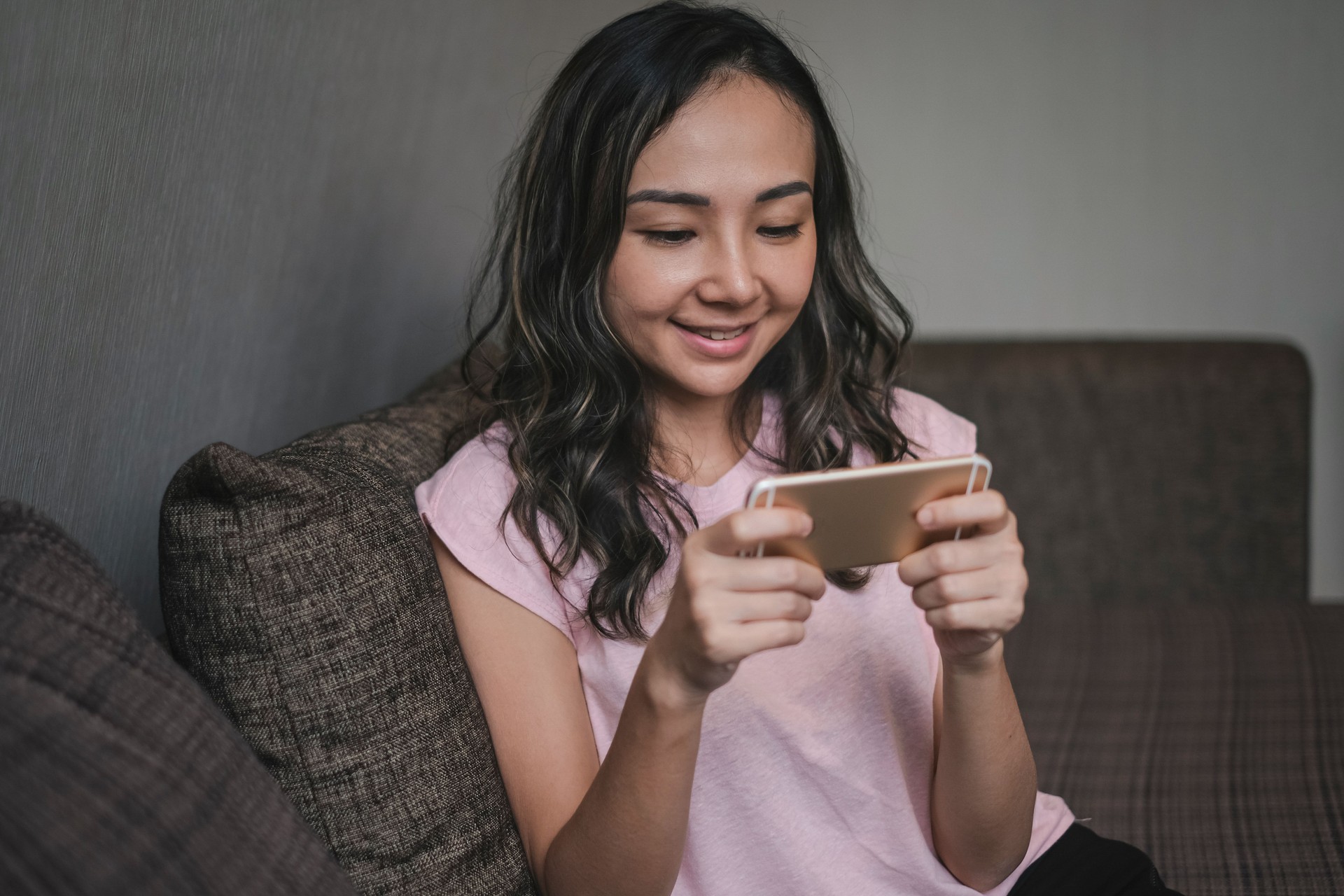 Asian Woman Playing Mobile Games on Phone